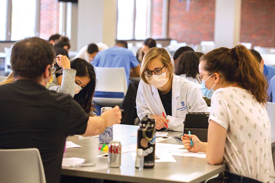 Students sitting around the table in their learning community