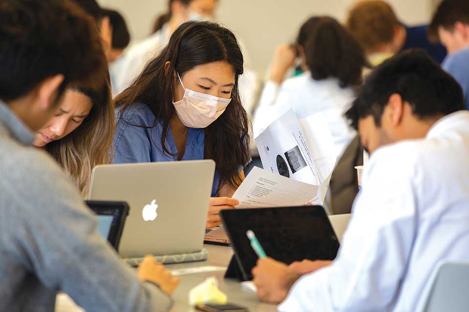 Student looking at her notes in her learning community