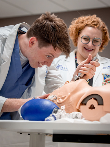 One student works with a human simulator.