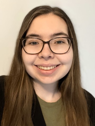 Young woman with long brown hair and glasses.